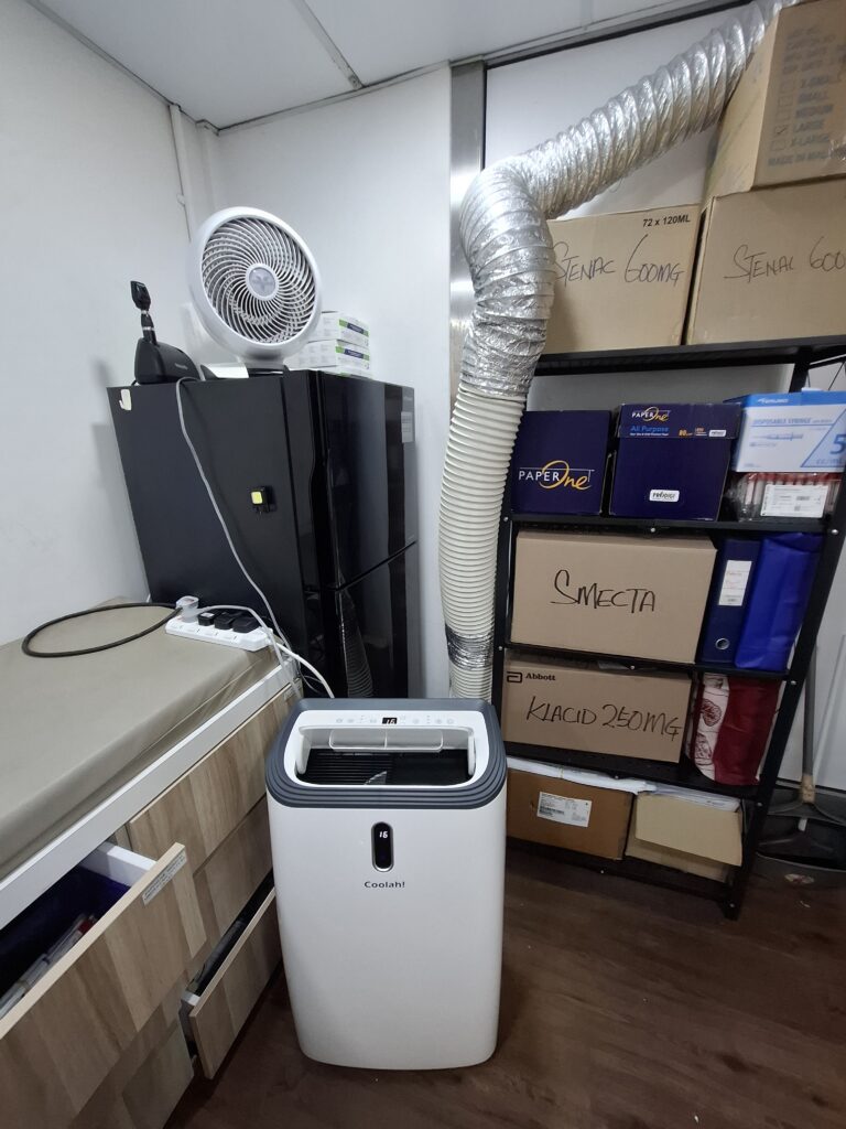Coolah portable air conditioner with exhaust hose installed for emergency cooling in a Singapore clinic
